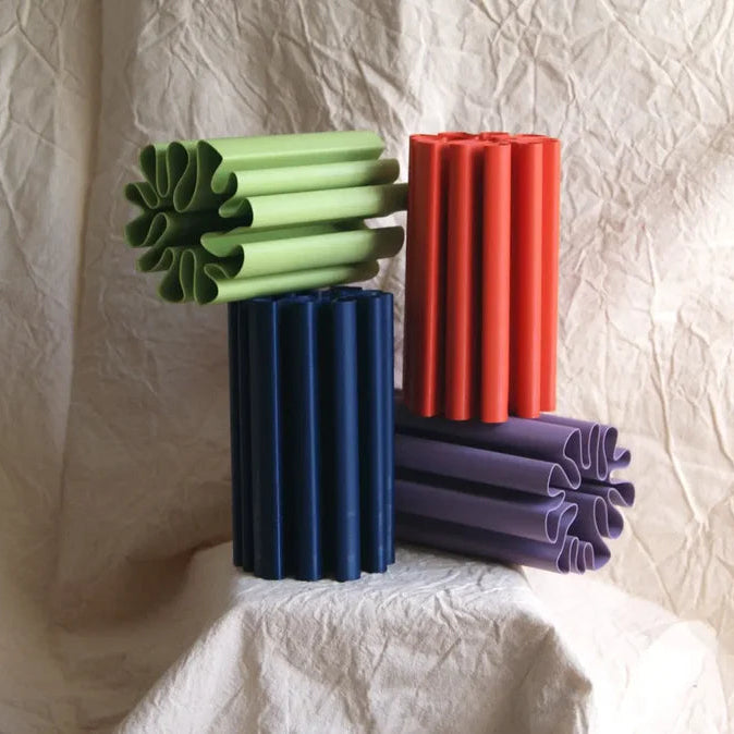 Colorful textured vases on a textured white surface